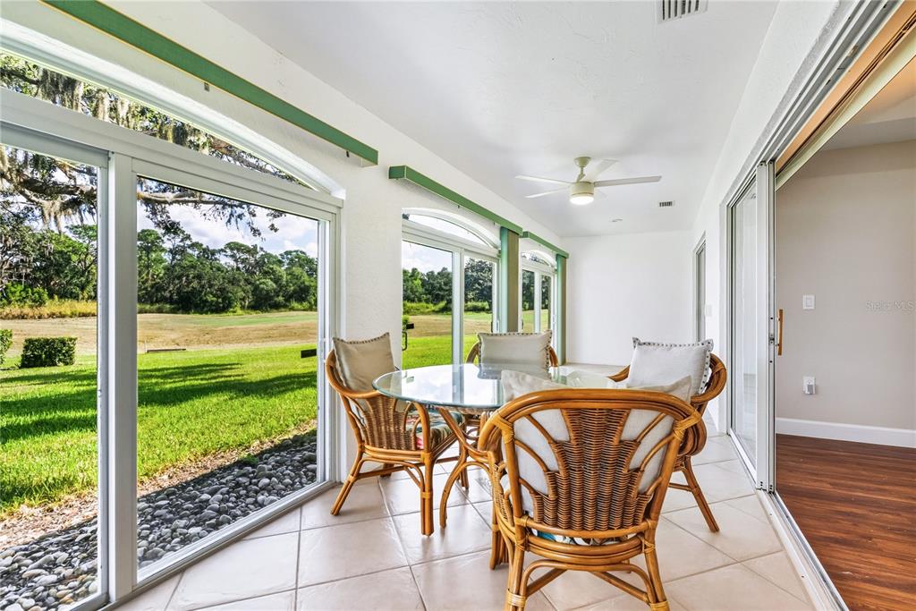 4016 Oakley Greene, Unit 40 Sarasota, FL 34235 - Photo 13 of 51 a dining room with furniture and floor to ceiling windows