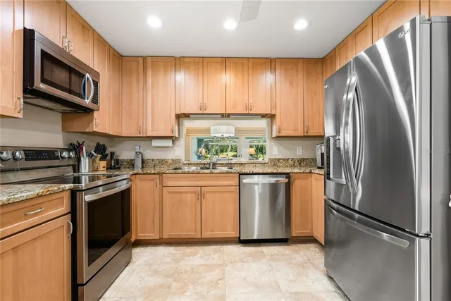 an aerial view of a house with a garden and lake view