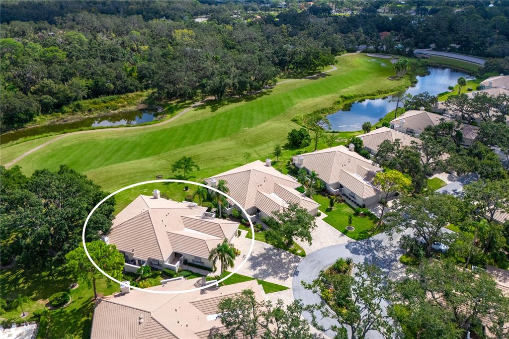 4016 Oakley Greene, Unit 40 Sarasota, FL 34235 - Photo 2 of 51 an aerial view of a house with a garden and lake view