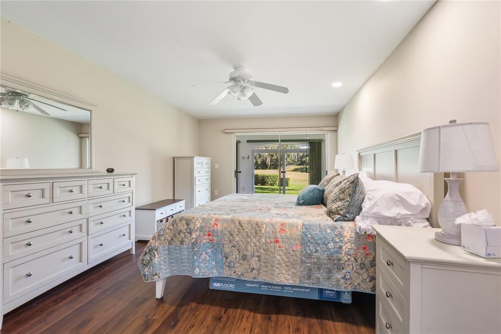 4016 Oakley Greene, Unit 40 Sarasota, FL 34235 - Photo 21 of 51 a bedroom with a large bed and a dresser