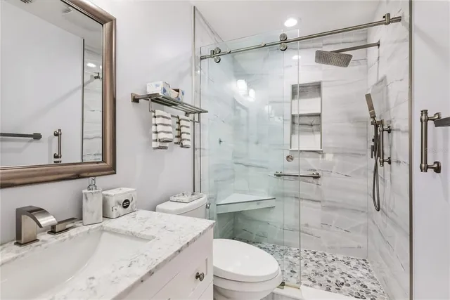 a view of a table and chairs under an umbrella in patio of a house