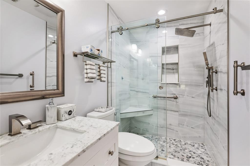 4016 Oakley Greene, Unit 40 Sarasota, FL 34235 - Photo 22 of 51 a bathroom with a granite countertop sink toilet a mirror and shower