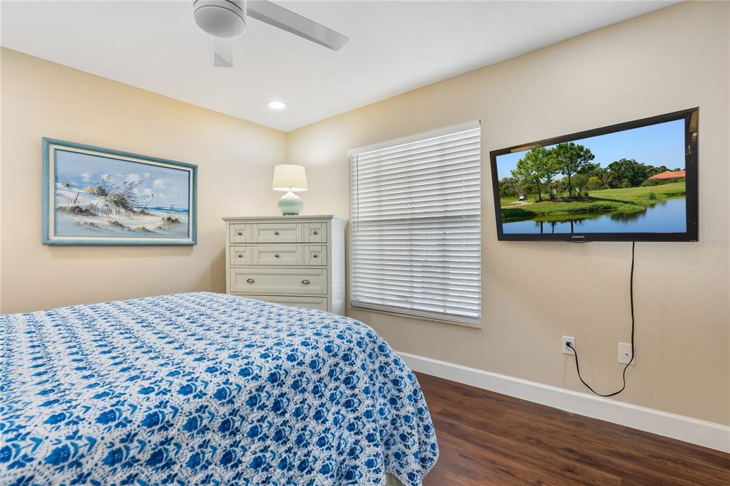 4016 Oakley Greene, Unit 40 Sarasota, FL 34235 - Photo 24 of 51 a bedroom with a bed and a painting on the wall