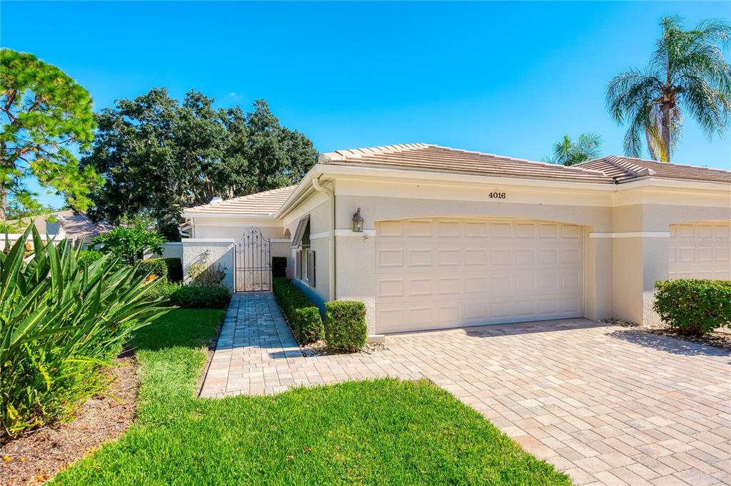 4016 Oakley Greene, Unit 40 Sarasota, FL 34235 - Photo 3 of 51 a front view of a house with a yard