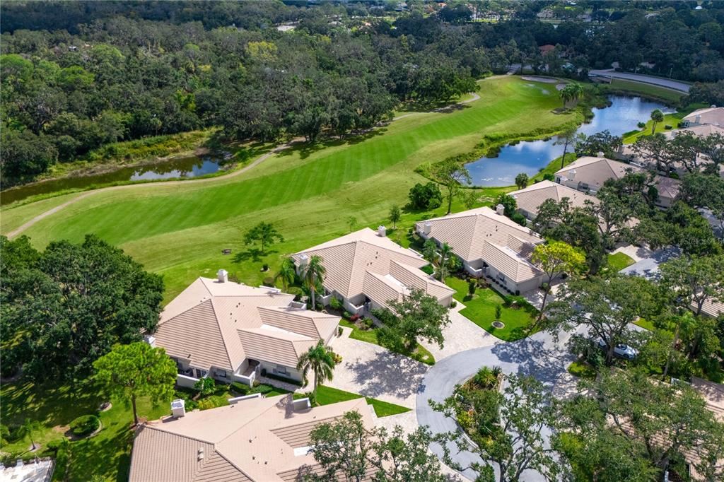 4016 Oakley Greene, Unit 40 Sarasota, FL 34235 - Photo 37 of 51 an aerial view of a house with a garden and lake view