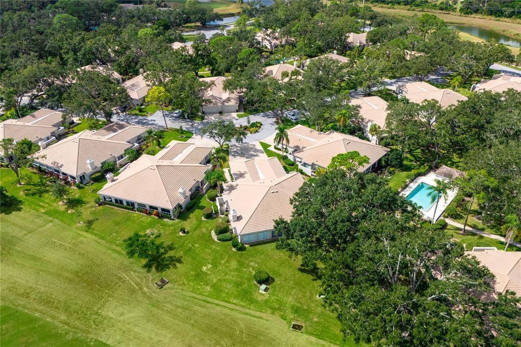 4016 Oakley Greene, Unit 40 Sarasota, FL 34235 - Photo 39 of 51 an aerial view of residential house with outdoor space and trees all around