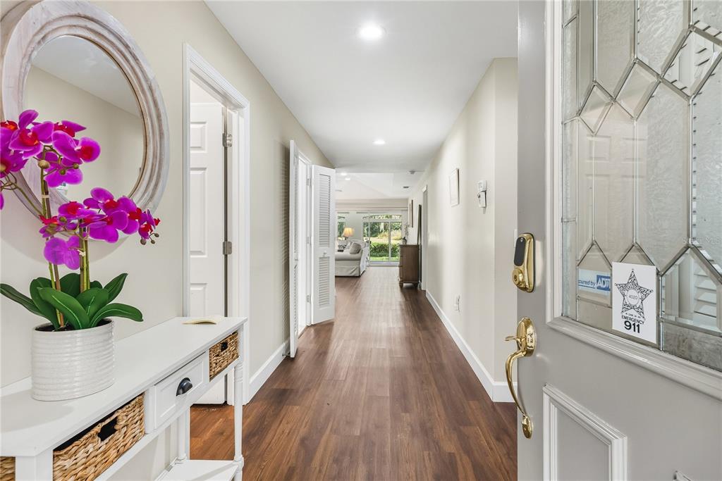 4016 Oakley Greene, Unit 40 Sarasota, FL 34235 - Photo 7 of 51 a hallway with beautiful flowers and wooden floor