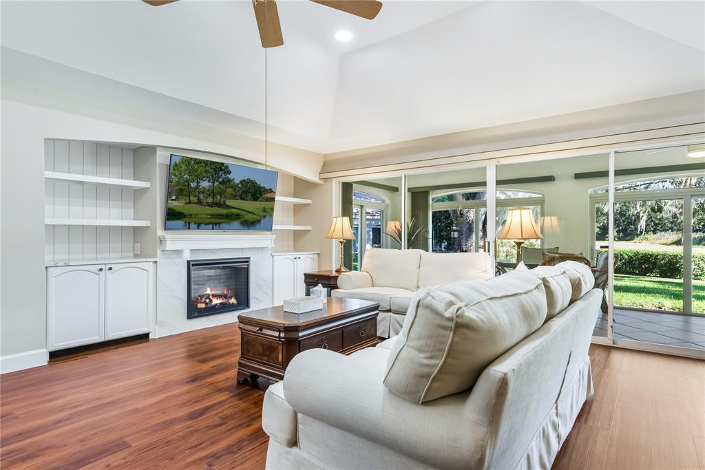 4016 Oakley Greene, Unit 40 Sarasota, FL 34235 - Photo 9 of 51 a living room with furniture fireplace and flat screen tv