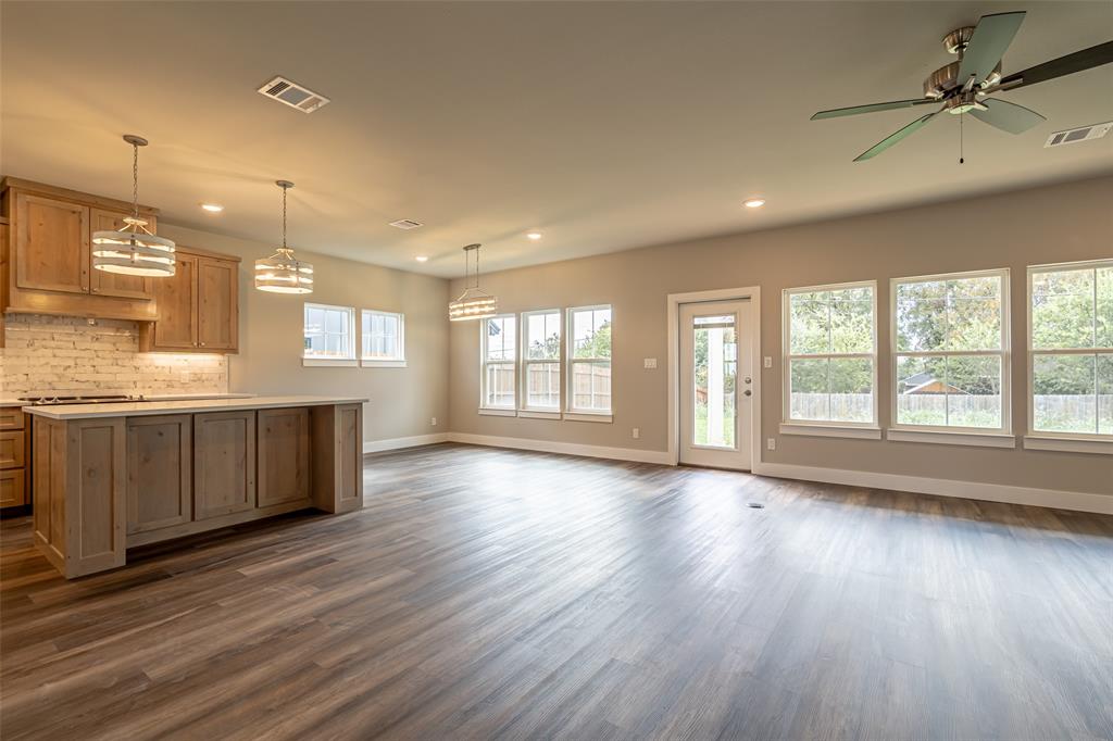 2044 Salina Circle Granbury, TX 76048 - Photo 11 of 38 a view of an empty room with window and wooden floor