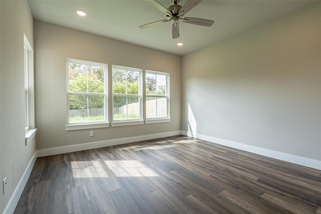2044 Salina Circle Granbury, TX 76048 - Photo 13 of 38 a view of an empty room with wooden floor and a window