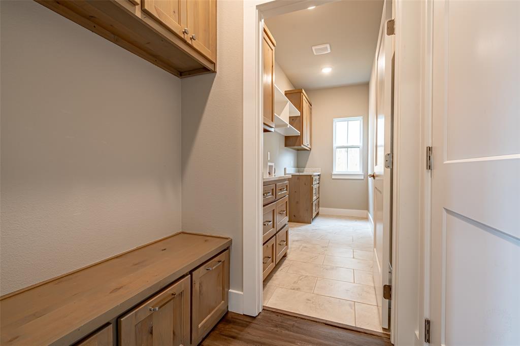 2044 Salina Circle Granbury, TX 76048 - Photo 14 of 38 a view of a hallway with wooden floor and a bathroom