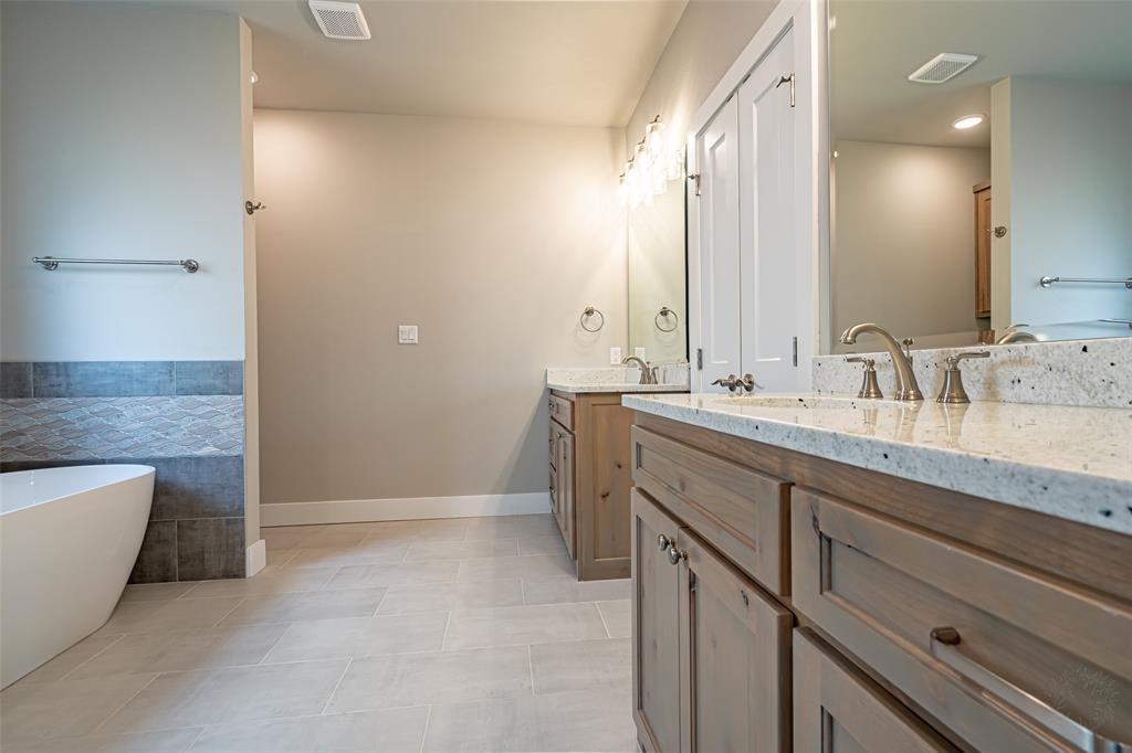 2044 Salina Circle Granbury, TX 76048 - Photo 18 of 38 a bathroom with a granite countertop sink and a bathtub