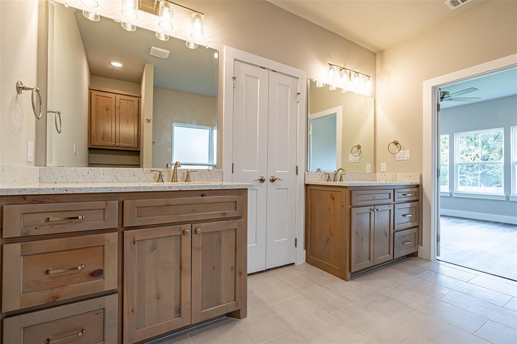 2044 Salina Circle Granbury, TX 76048 - Photo 19 of 38 a bathroom with a granite countertop sink mirror and double