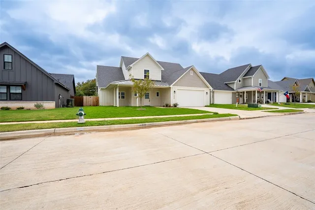 a front view of a house with a garden and yard
