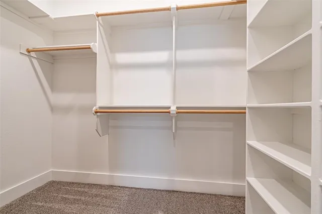 a view of an empty room and a ceiling fan