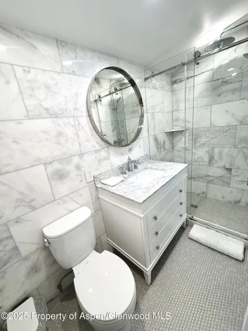 a bathroom with a double vanity sink mirror and toilet
