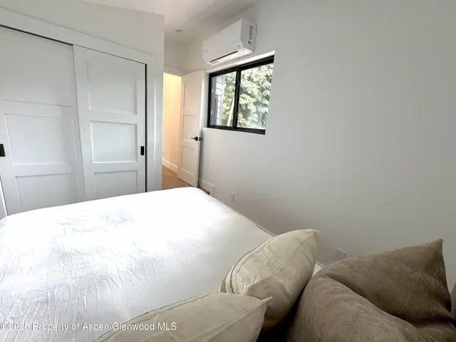 a bedroom with a bed couch and window