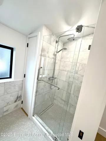 a bathroom with a glass door shower