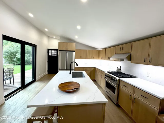 a kitchen with a stove and a refrigerator