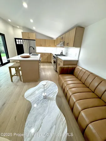 a living room with furniture and kitchen view