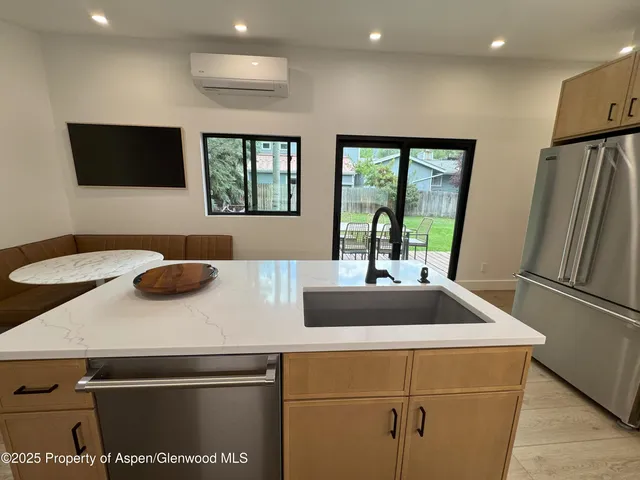 a kitchen with a sink and a refrigerator