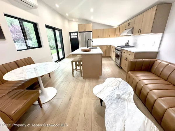 a living room with furniture and a dining table