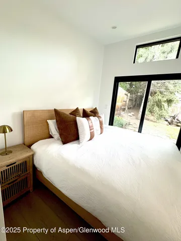 a bedroom with a bed and a large window