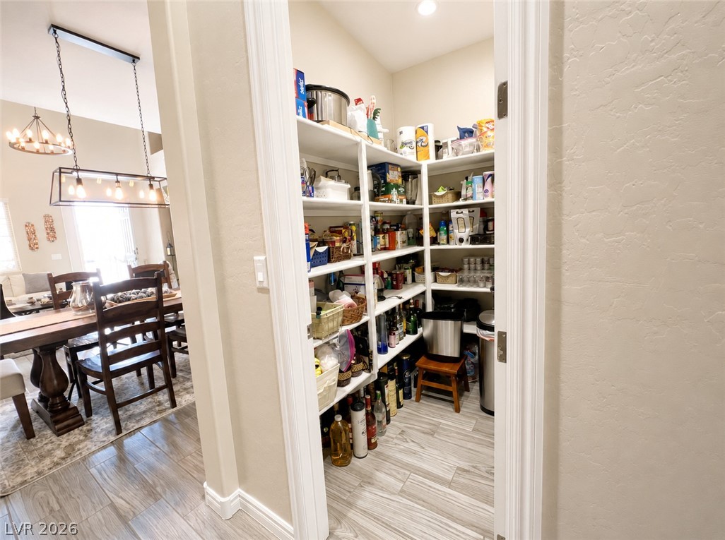 9724 University Ridge Avenue Las Vegas, NV 89149 - Photo 53 of 61 Ample storage within this organized pantry, conveniently situated adjacent to an inviting dining space.