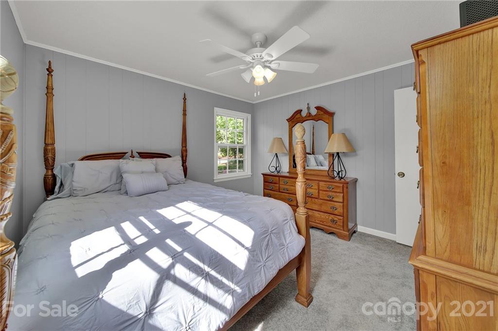 1505 Flat Creek Road Lancaster, SC 29720 - Photo 22 of 39 a bedroom with a bed and a chandelier