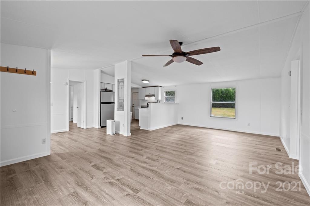 175 Reading Road Salisbury, NC 28147 - Photo 11 of 38 a view of a kitchen with wooden floor and a ceiling fan