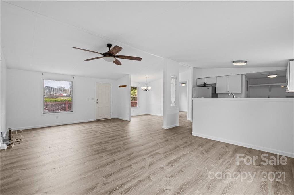 175 Reading Road Salisbury, NC 28147 - Photo 12 of 38 an empty room with wooden floor and a ceiling fan