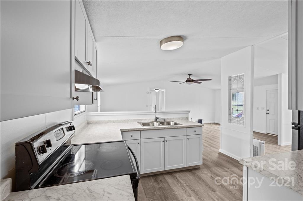 175 Reading Road Salisbury, NC 28147 - Photo 21 of 38 a kitchen with a sink appliances and cabinets