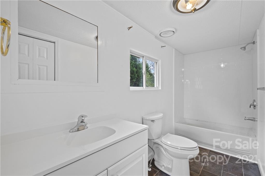 175 Reading Road Salisbury, NC 28147 - Photo 33 of 38 a white toilet sitting next to a bathroom sink