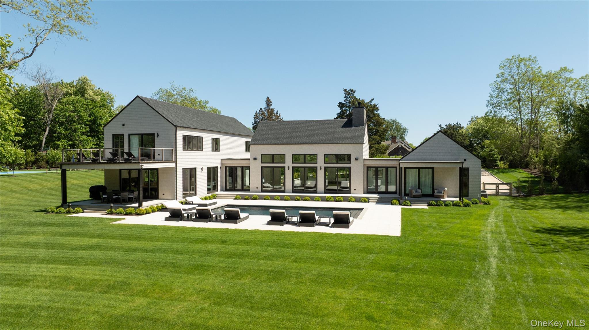 a front view of house with yard and lake view