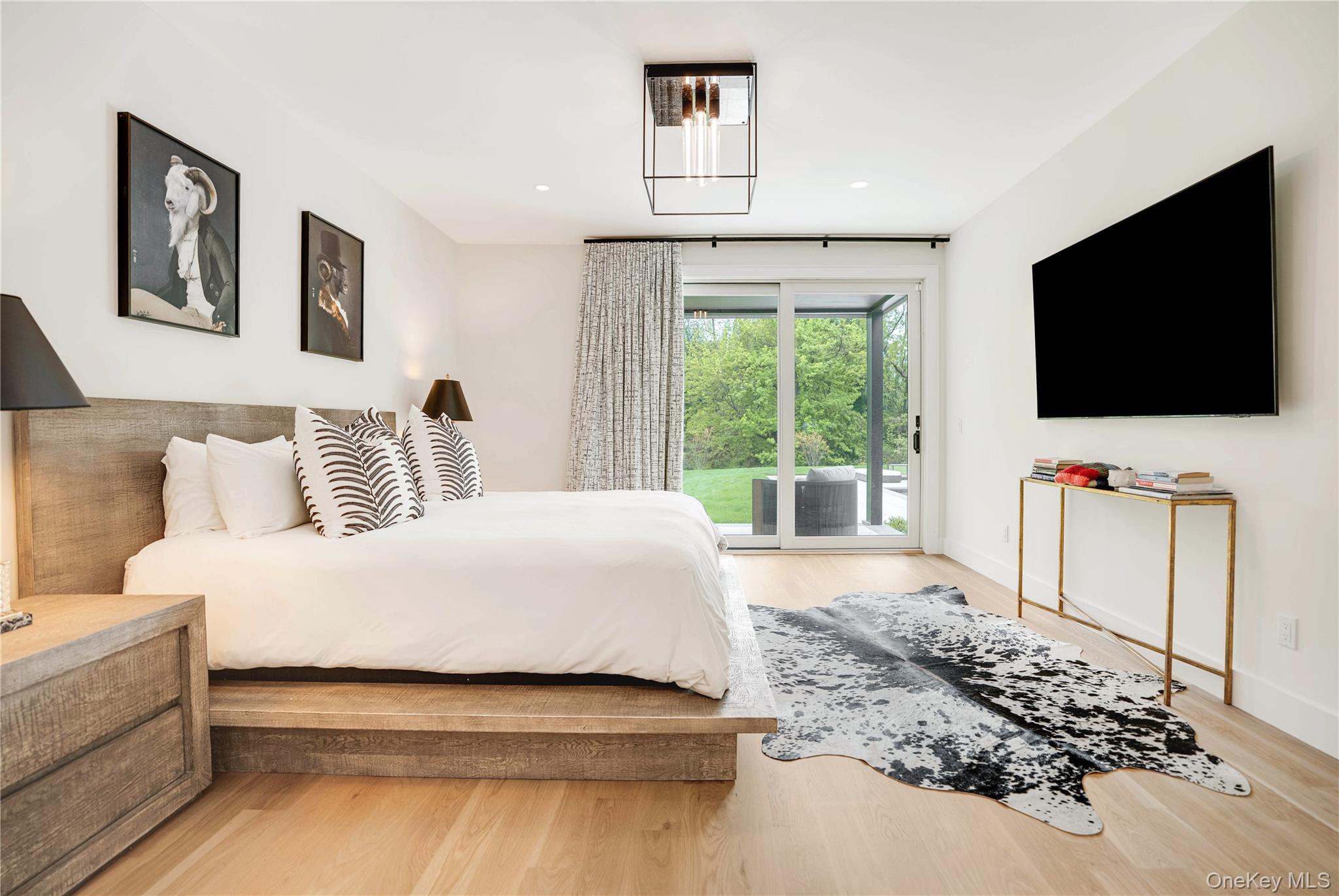 100 South Ferry Road Shelter Island, NY 11964 - Photo 14 of 28 a bedroom with a bed and a flat screen tv