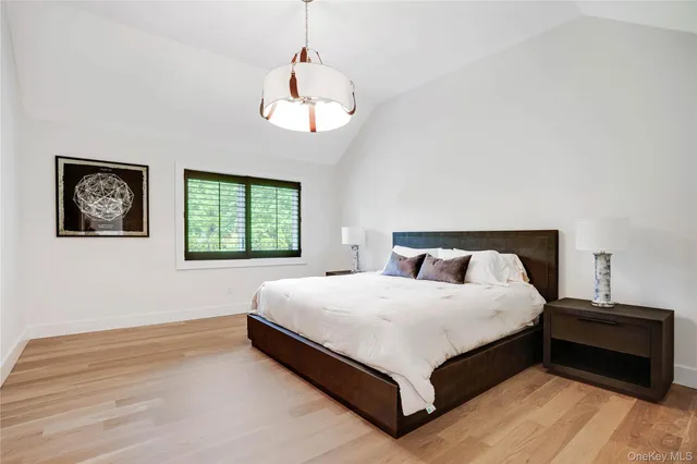 a bedroom with a large bed and a window