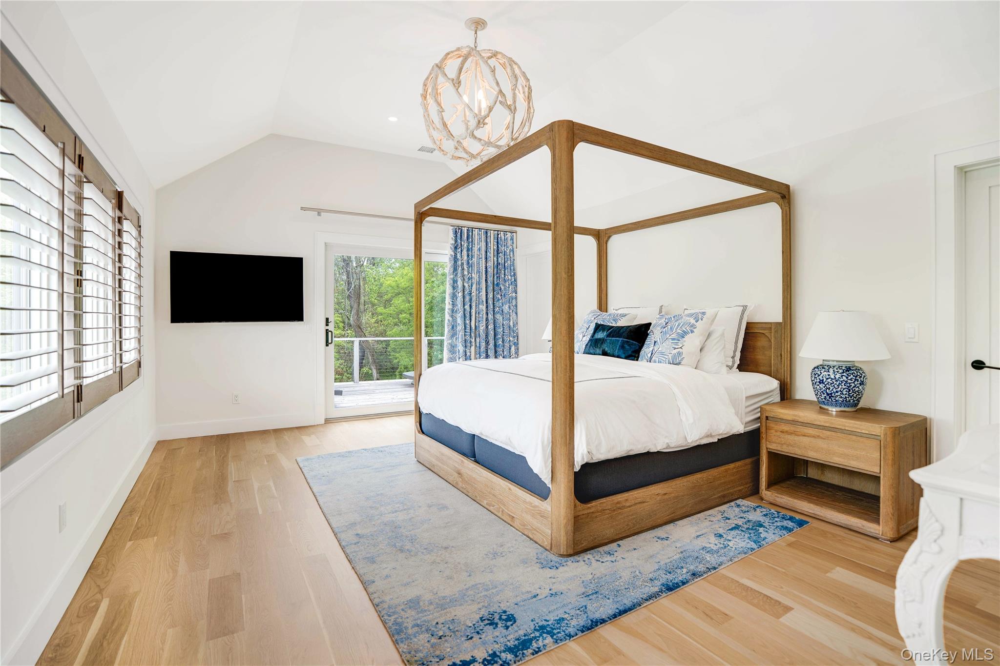 100 South Ferry Road Shelter Island, NY 11964 - Photo 21 of 28 a bedroom with a bed flat screen tv and a large window