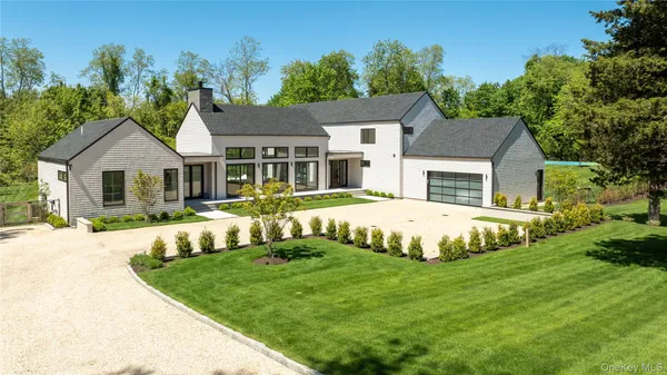 a view of house with a yard and swimming pool