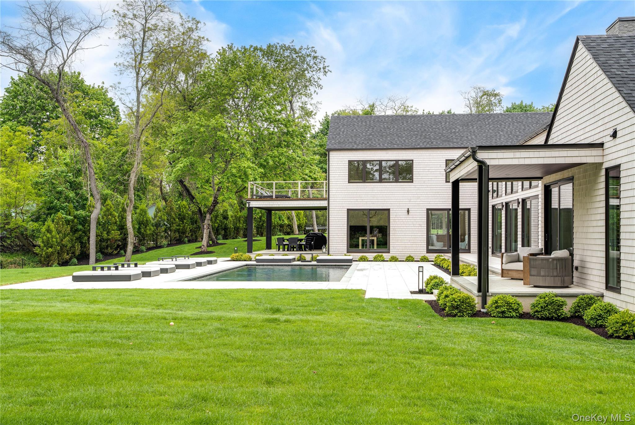 100 South Ferry Road Shelter Island, NY 11964 - Photo 4 of 28 a view of a house with a backyard