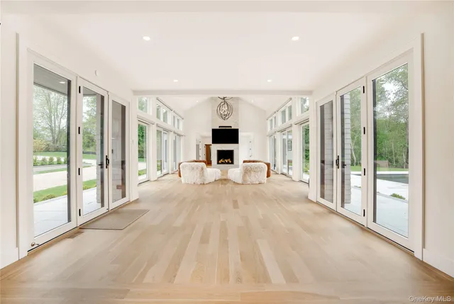 a view of a livingroom with wooden floor and a fireplace