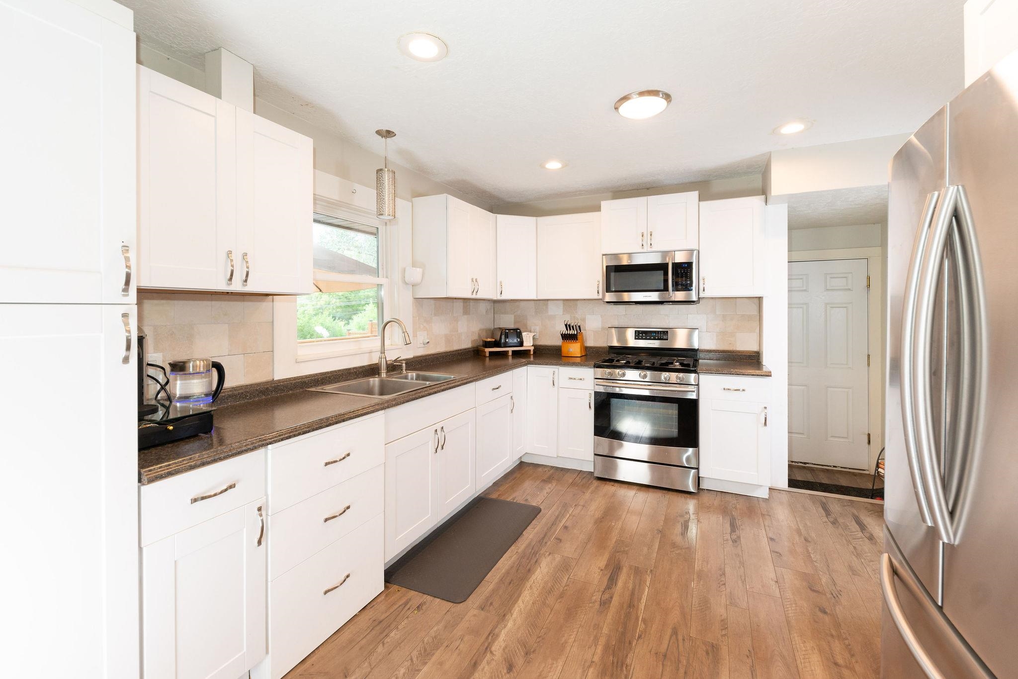 4743 Welsh Road Rockford, IL 61107 - Photo 17 of 52 a kitchen with granite countertop white cabinets and stainless steel appliances