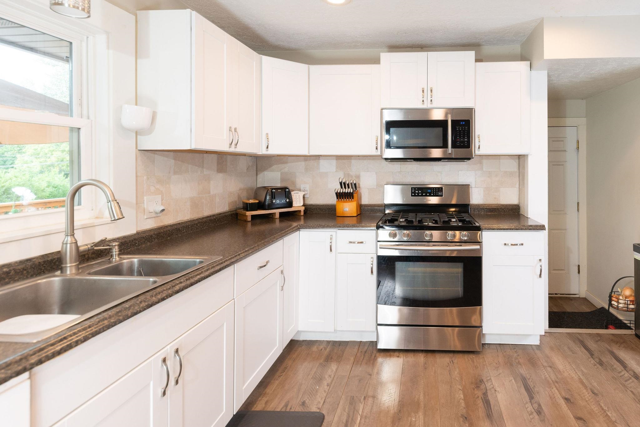 4743 Welsh Road Rockford, IL 61107 - Photo 19 of 52 a kitchen with stainless steel appliances a sink stove and microwave