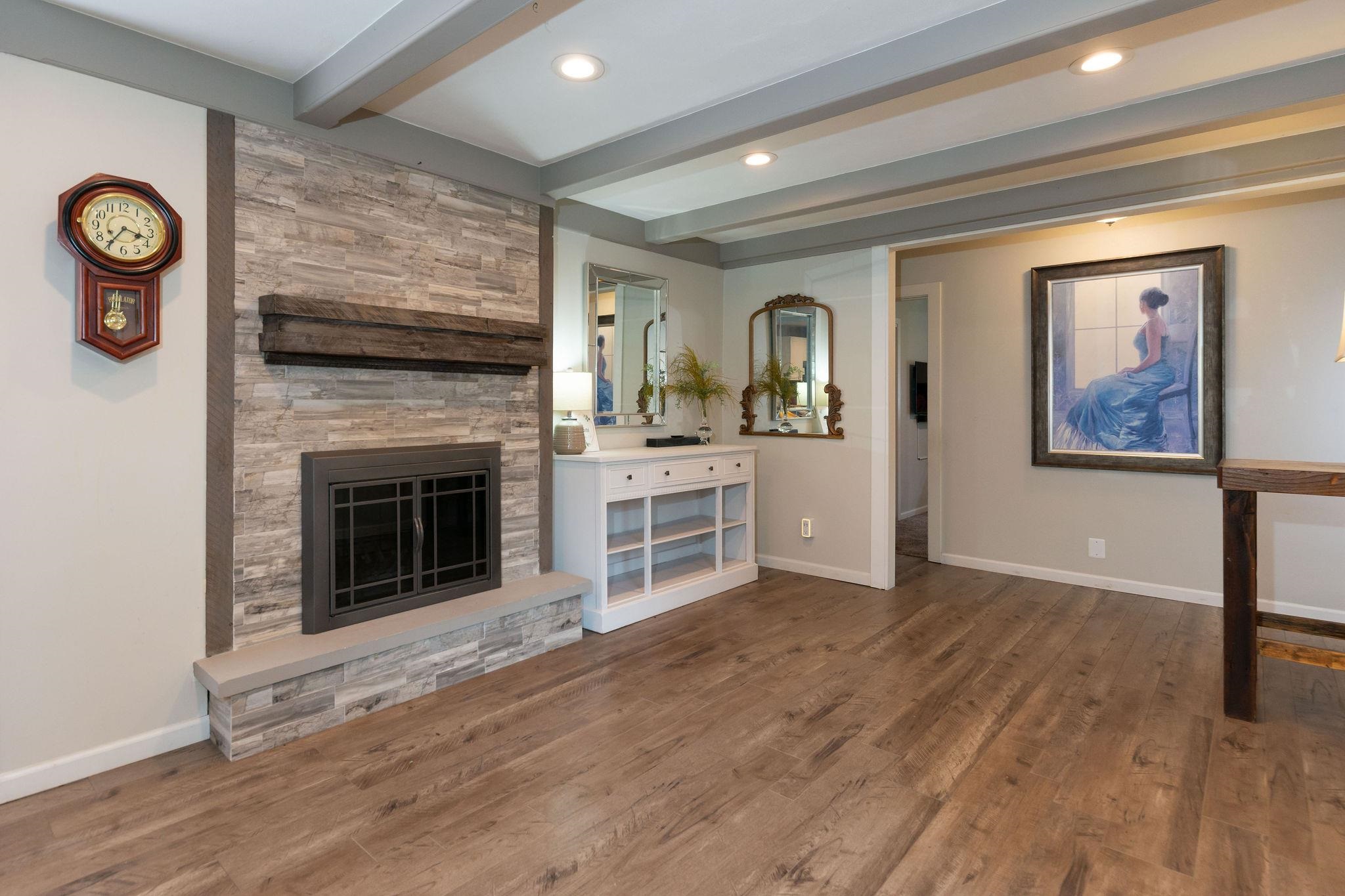 4743 Welsh Road Rockford, IL 61107 - Photo 23 of 52 a view of a livingroom with a fireplace a sink and dishwasher wooden floor