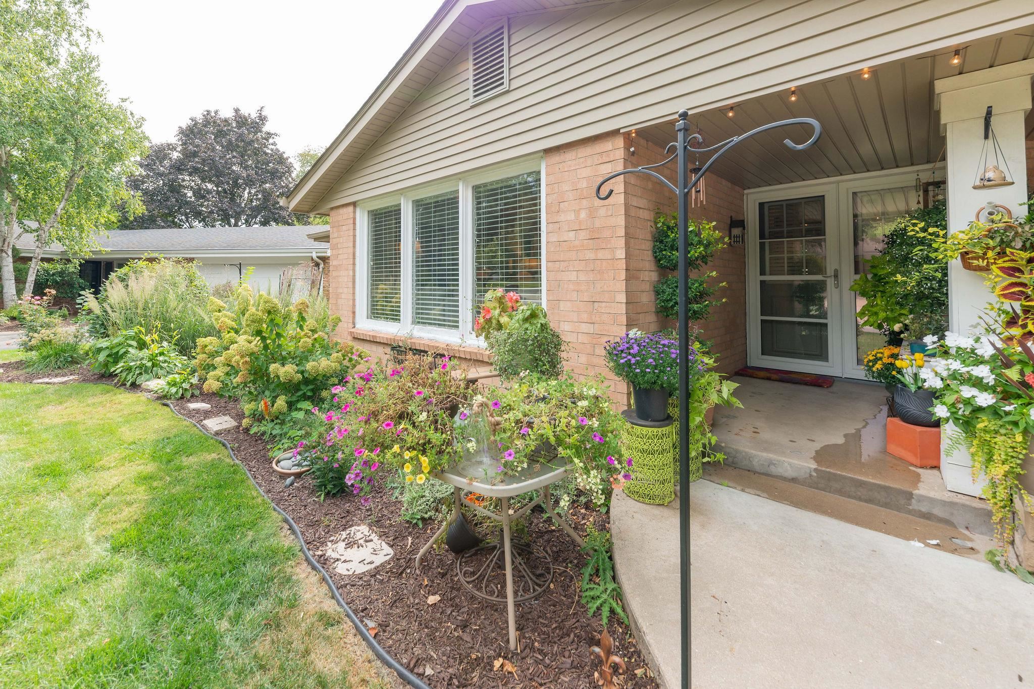 4743 Welsh Road Rockford, IL 61107 - Photo 6 of 52 a front view of a house with a yard and table and chair