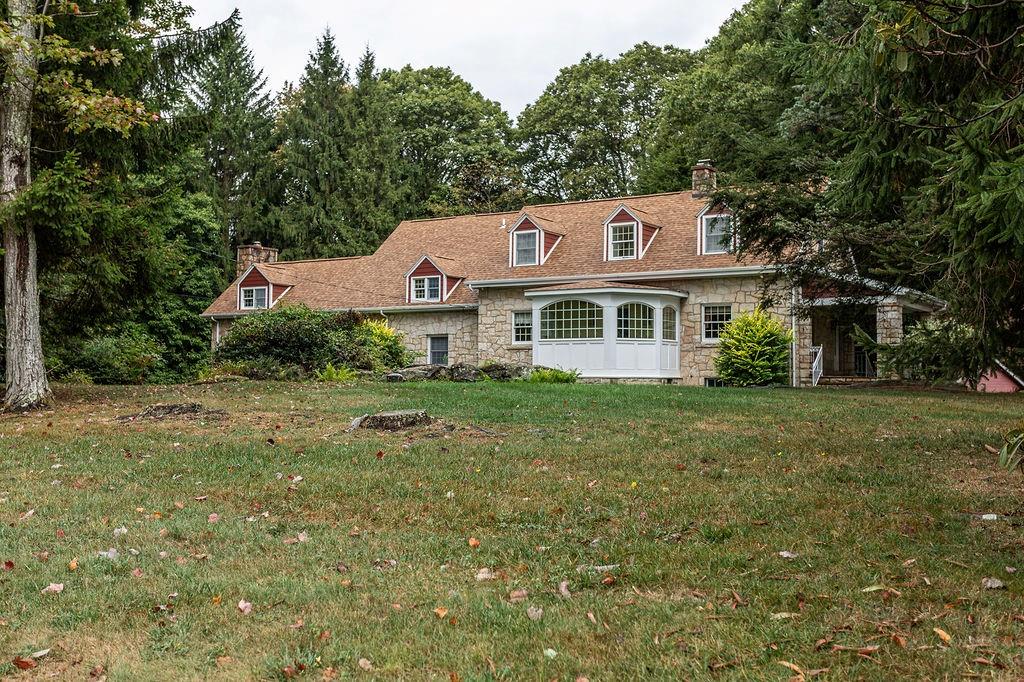 2541 Springfield Pike Connellsville, PA 15425 - Photo 13 of 49 a front view of a house with a garden and plants