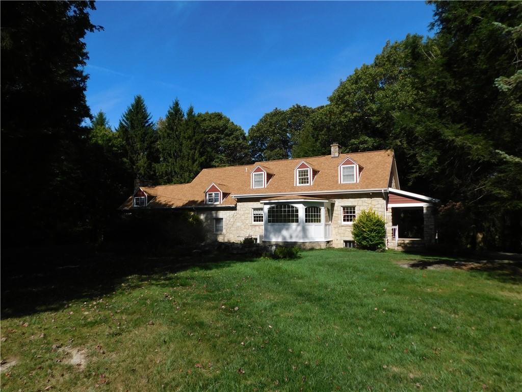 2541 Springfield Pike Connellsville, PA 15425 - Photo 20 of 49 a roof deck with table and chairs under an umbrella with large trees