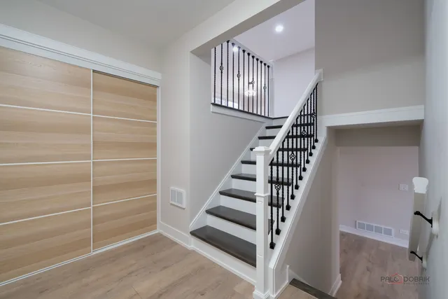 a view of entryway with wooden floor and stairs