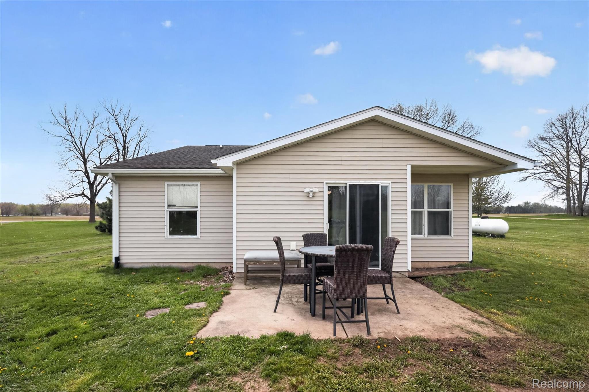 45196 76th Avenue Decatur, MI 49045 - Photo 20 of 23 Rear view of property featuring a yard and a patio