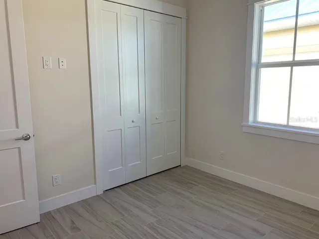 a bathroom with a granite countertop toilet a sink a mirror and shower