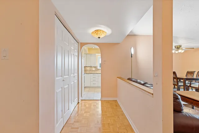 a view of a hallway to a bedroom with wooden floor